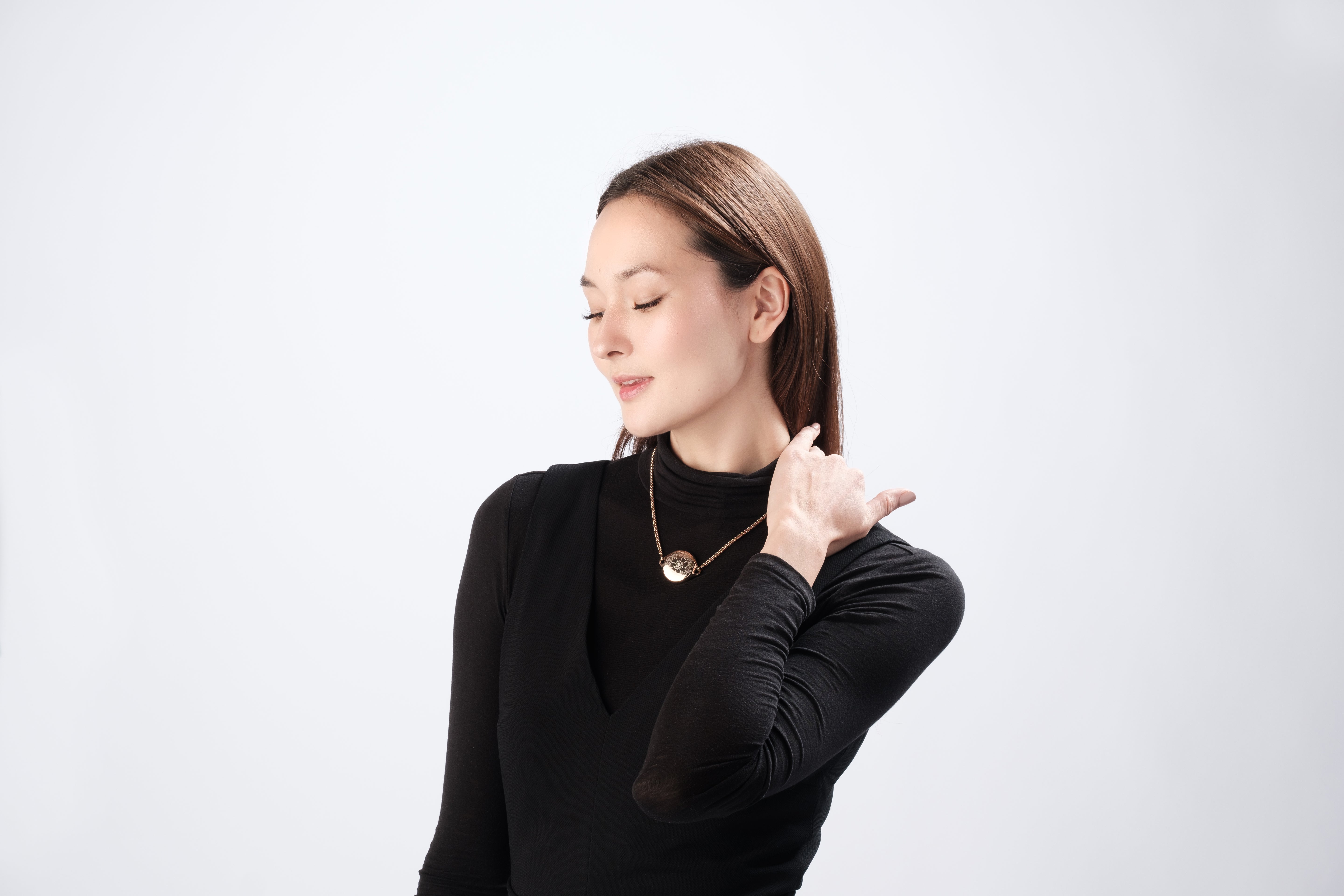 Elegant woman modeling ResQ safety necklace.