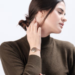 Woman wearing ResQ rose gold safety bracelet.