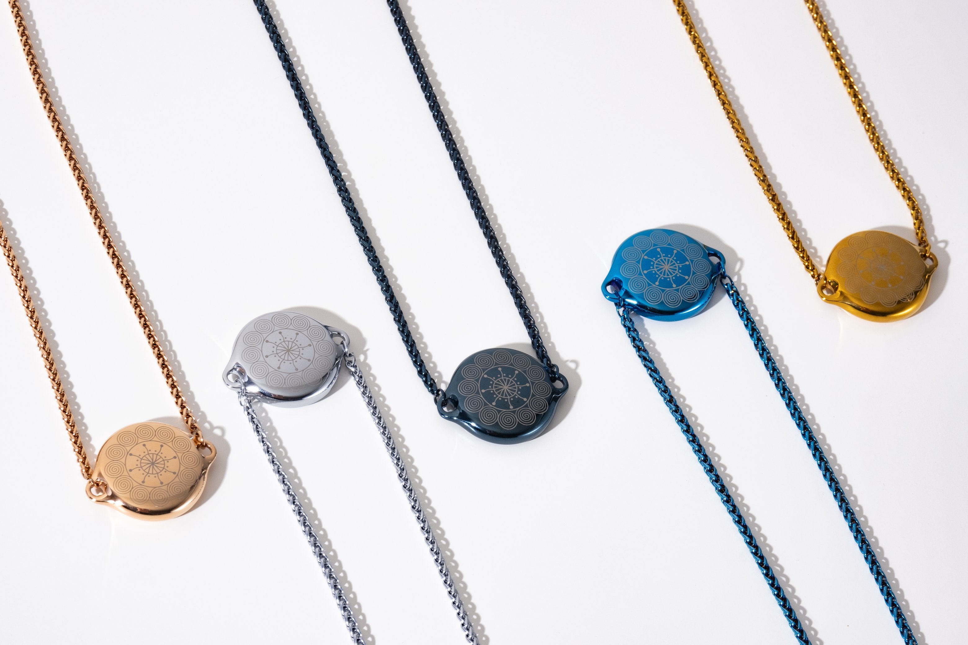 ResQ wearable safety devices collection - stylish women's protection necklaces in rose gold, silver, black, blue and gold colors for personal security and emergency safety.