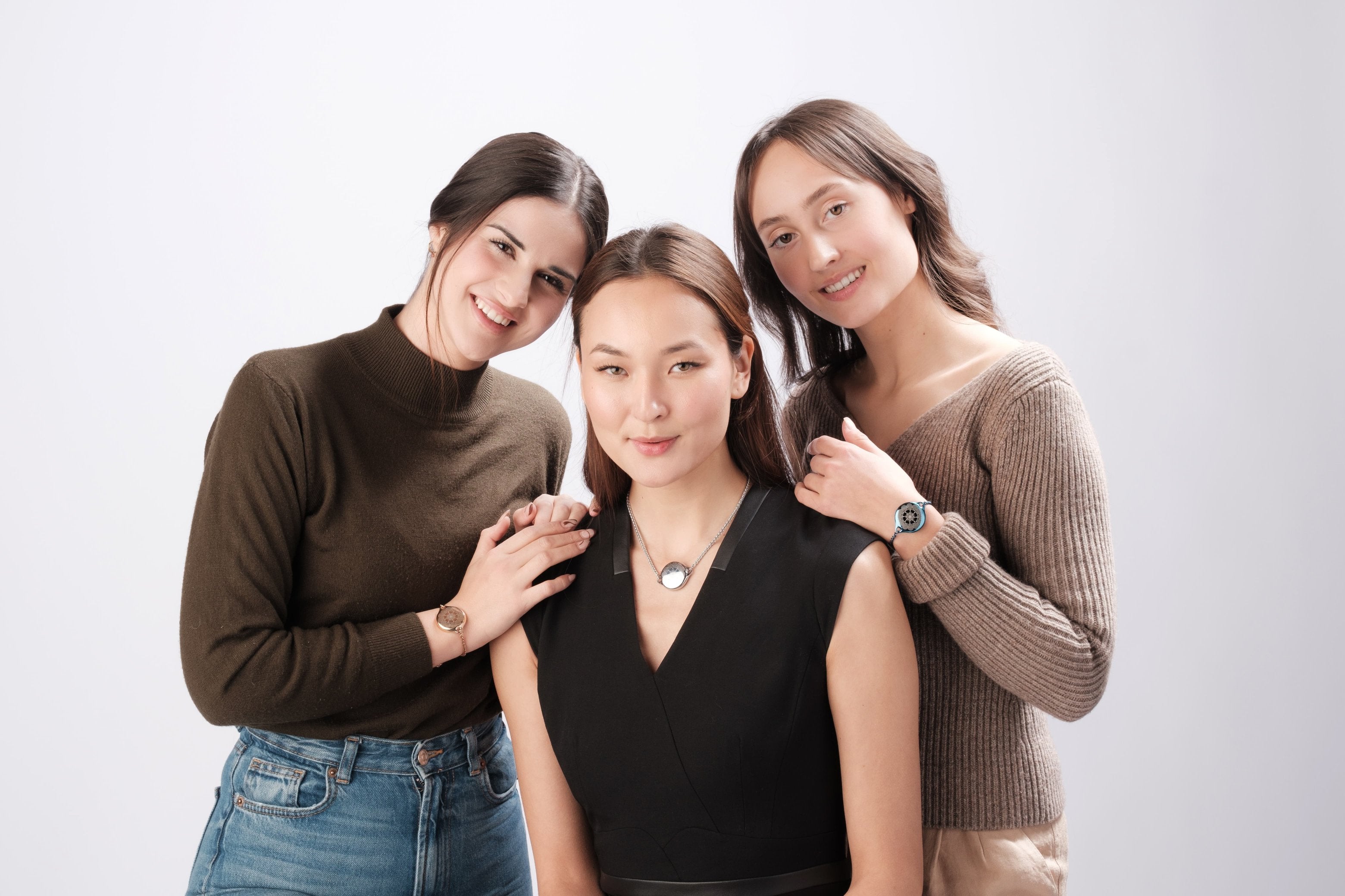 Three women friends wearing ResQ safety jewelry.