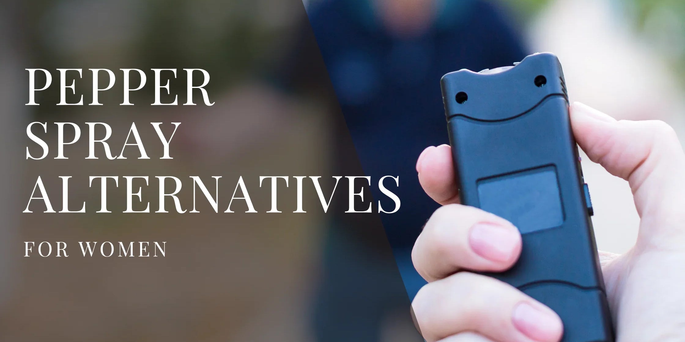 A person holds a compact black self defense device in their hand, with a blurred outdoor background behind them.