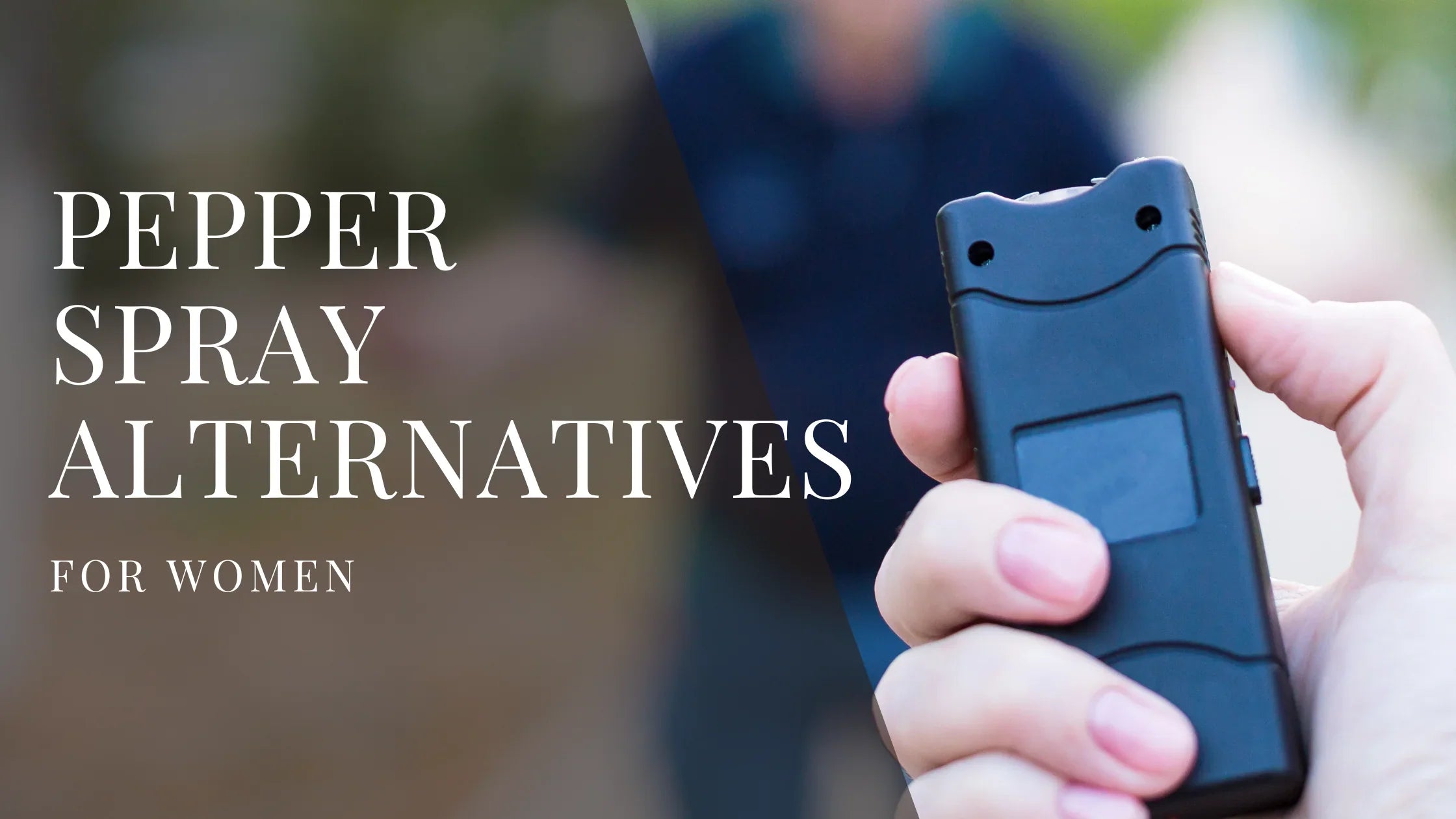 A person holds a compact black self defense device in their hand, with a blurred outdoor background behind them.