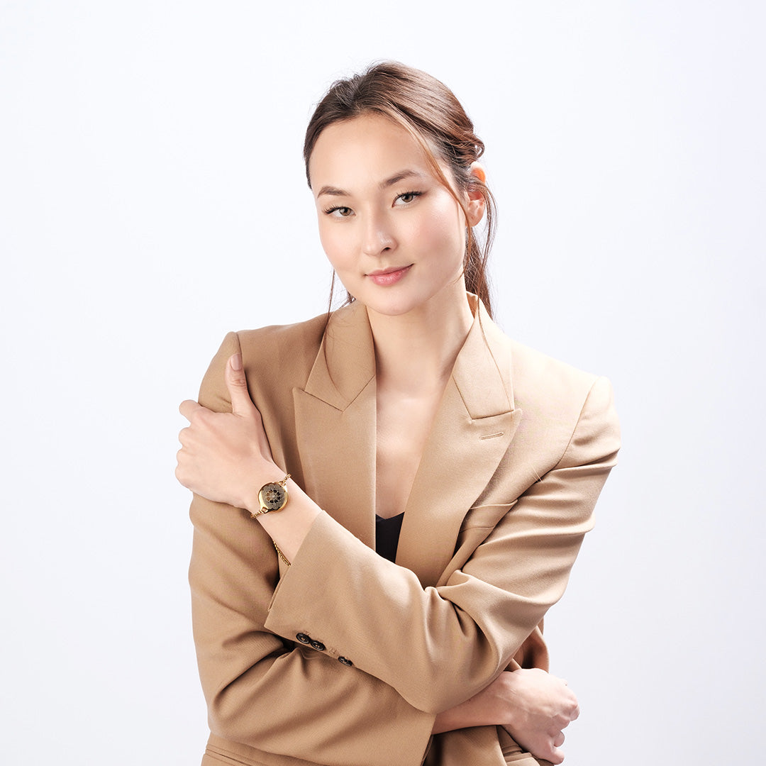 Woman wearing ResQ Maitri safety bracelet with gold finish for personal security and protection.