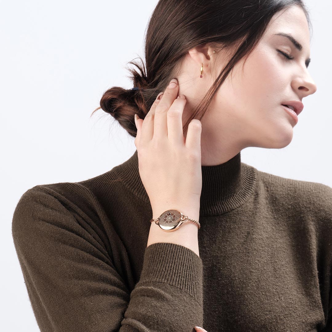 Woman wearing blue ResQ Maitri safety bracelet (Rose Gold) with emergency alert technology for women’s protection.