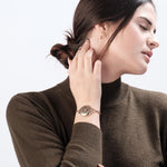 Woman wearing blue ResQ Maitri safety bracelet (Rose Gold) with emergency alert technology for women’s protection.