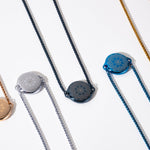 ResQ wearable safety devices collection - stylish women's protection necklaces in rose gold, silver, black, blue and gold colors for personal security and emergency safety.