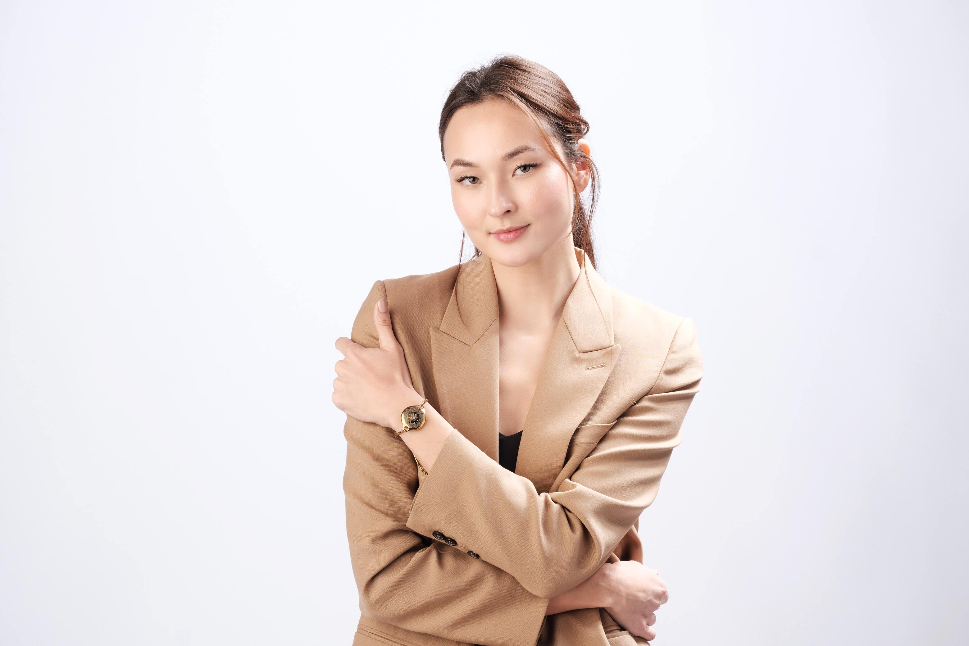 Professional businesswoman wearing ResQ safety bracelet - stylish personal alarm jewelry for workplace protection and women's security.
